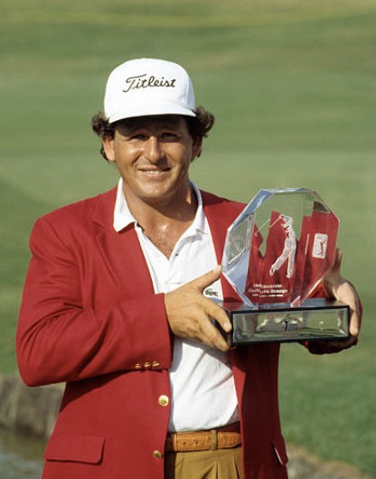 Fulton Allem in the champion’s red jacket holding a trophy